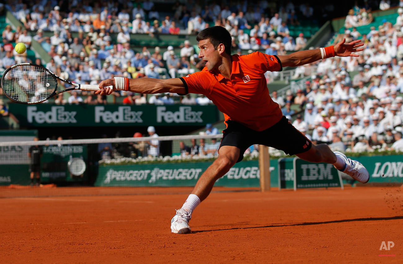 In this June 5, 2015 photo, Serbia's Novak Djokovic stretches to return the ball to Britain's Andy Murray, right, during their semifinal match of the French Open tennis tournament at the Roland Garros stadium in Paris, France. (AP Photo/Francois Mor