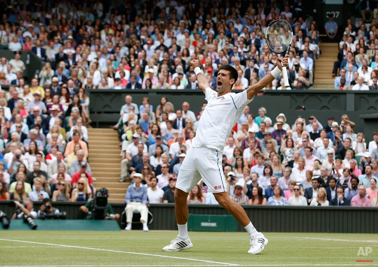 In this July 12, 2015 photo, Novak Djokovic of Serbia celebrates winning the men's singles final against Roger Federer of Switzerland at the All England Lawn Tennis Championships in Wimbledon, London. Djokovic won the match 7-6, 6-7, 6-4, 6-3. (AP Photo/Alastair Grant)
