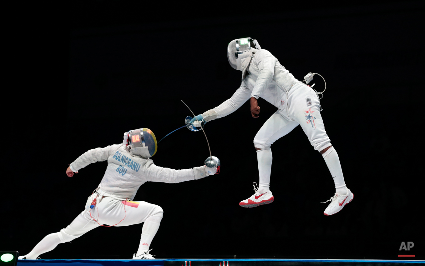  In this July 14, 2015 photo Tiberiu Dolniceanu, of Romania, left, and Daryl Homer, of the United States, right, in action during their semifinal match at sabre competition at the fencing World championships in Moscow, Russia. (AP Photo/Ivan Sekretar