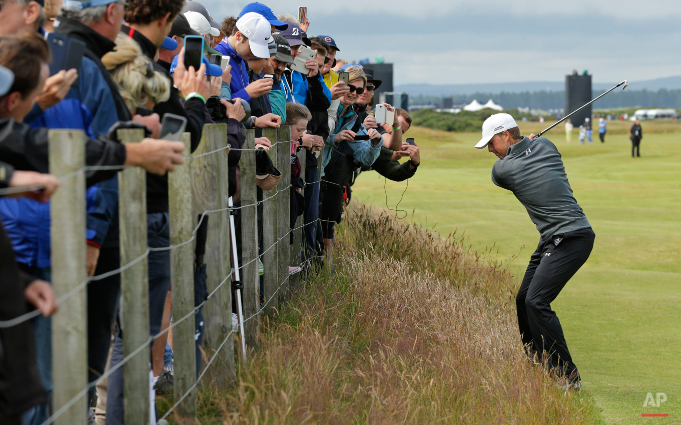  In this Wednesday, July 15, 2015 photo, United States' Jordan Spieth plays from the rough on hole 16 during a practice round at the British Open Golf Championship at the Old Course, St. Andrews, Scotland. (AP Photo/David J. Phillip) 
