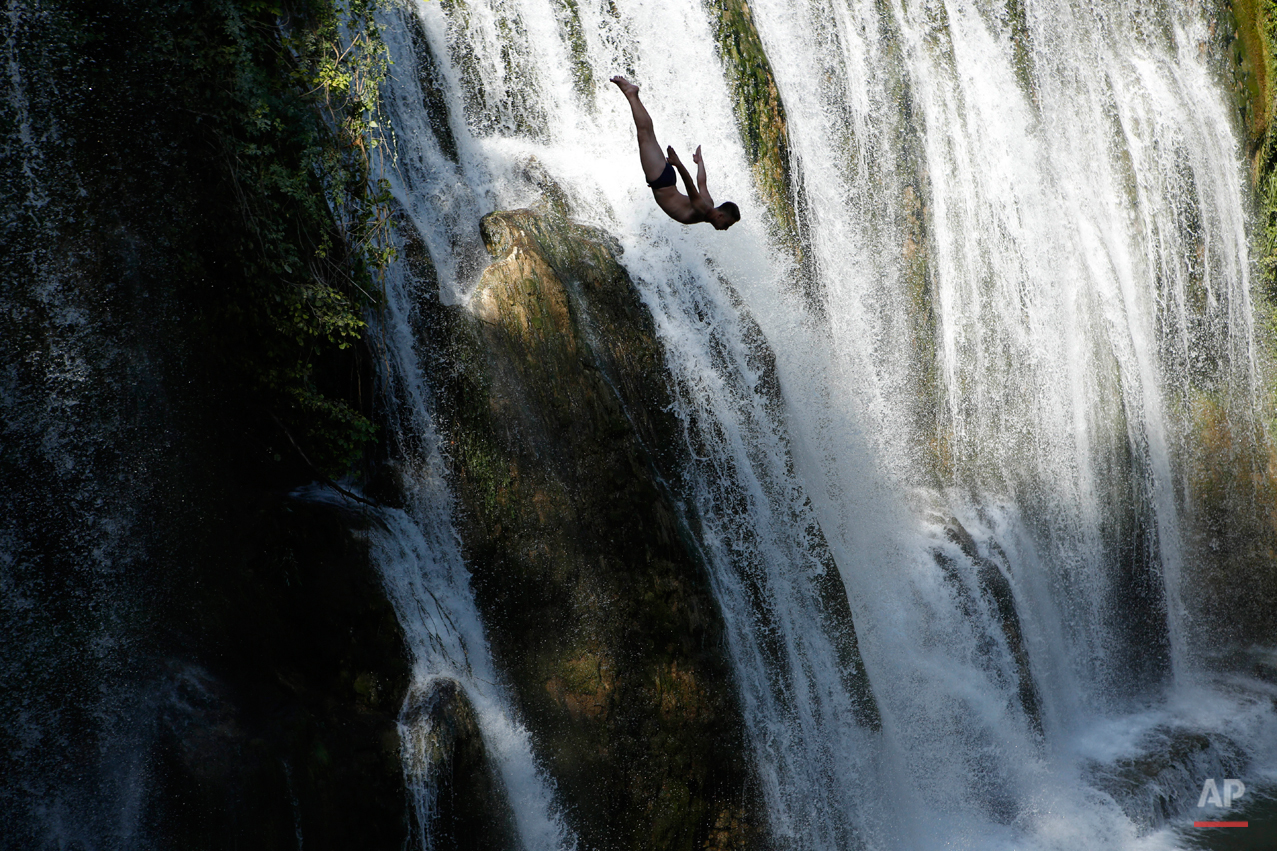  In this Aug. 1, 2015 photo a competitor dives during international waterfall jumping competition in the old town of Jajce, 250 kms west of Sarajevo, Bosnia.  Total of 25 competitors took part in this jumps from waterfall 20 meters high.(AP Photo/Ame