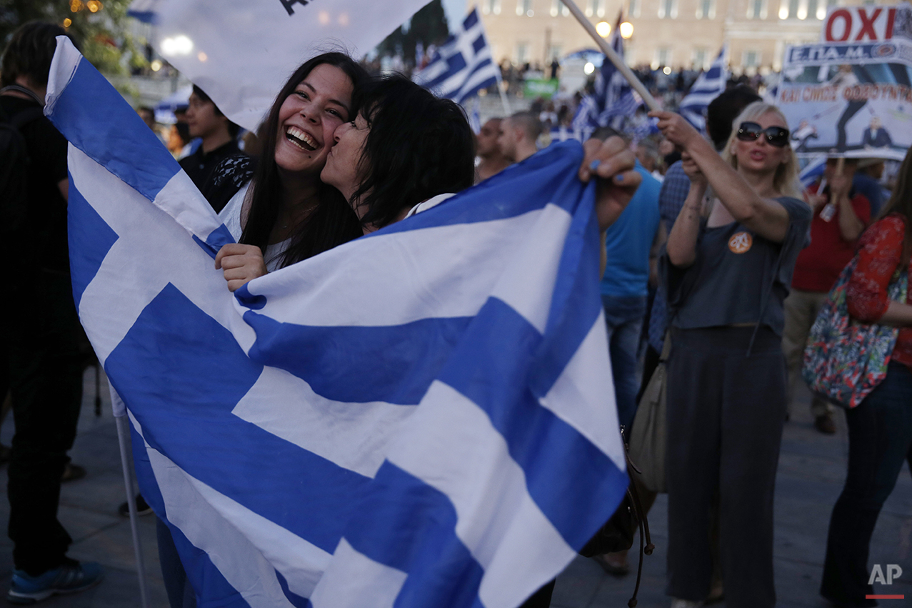  In this photo taken on Sunday, July 5, 2015, supporters of the No vote react after the results of the referendum at Syntagma square in Athens. Anyone hoping Greece might finally have a quiet year was quickly disappointed in 2015. Brinkmanship with b
