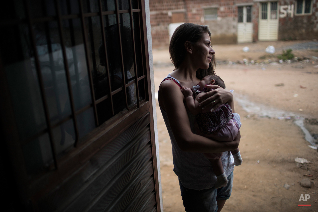  In this Dec. 22, 2015 photo, Angelica Pereira holds Luiza outside their house in Santa Cruz do Capibaribe, Pernambuco state, Brazil. Luiza was born in October with a rare condition, known as microcephaly. The Zika virus, first detected in humans abo