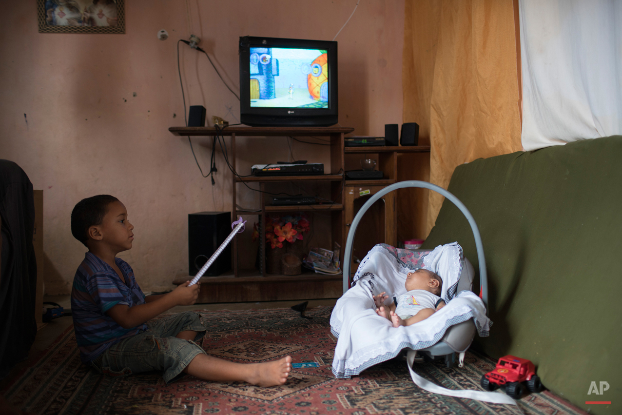  In this Dec. 23, 2015 photo, 5-year-old Elenilson, left, holds a notebook as he plays next to his 2-month-old brother Jose Wesley at their house in Poco Fundo, Pernambuco state, Brazil. Their mother, Solange Ferreira had never heard of microcephaly 