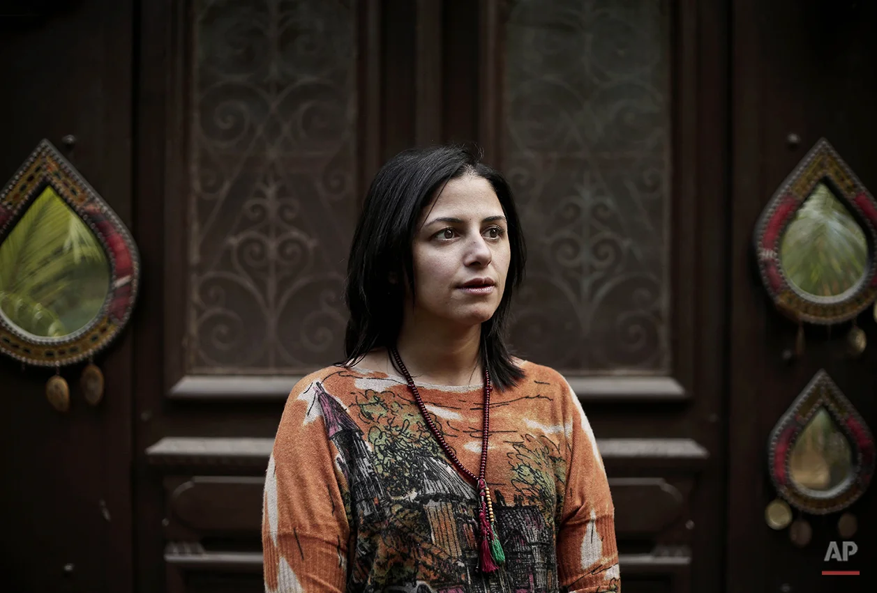 Ghalia Ibrahim, a 37-year old dentist and triathlete, poses for a photograph inside her home, during the fifth anniversary of the 2011 uprising, in Cairo, Egypt, Monday, Jan. 25, 2016. "I went on my bicycle to Tahrir Square and told the pro-regime people celebrating there that President Abdel-Fattah El-Sissi came to power because of the Jan. 25 revolution. I am very positive and hopeful that the country has a bright future. The people have to start working and stop criticizing," says Ibrahim. (AP Photo/Nariman El-Mofty)
