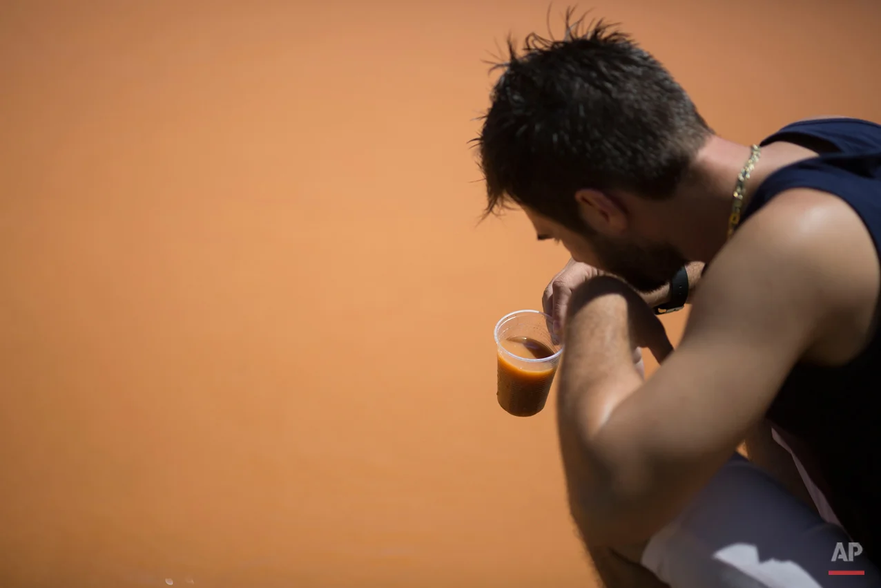  In this Nov. 21, 2015 photo, Thiago Palassi collects a cup of water from the Doce River, in Colatina, Brazil. The flood of mud unleashed by the dam burst at the Samarco mine all but erased a nearby hamlet. The wave spilled into the Doce River, where