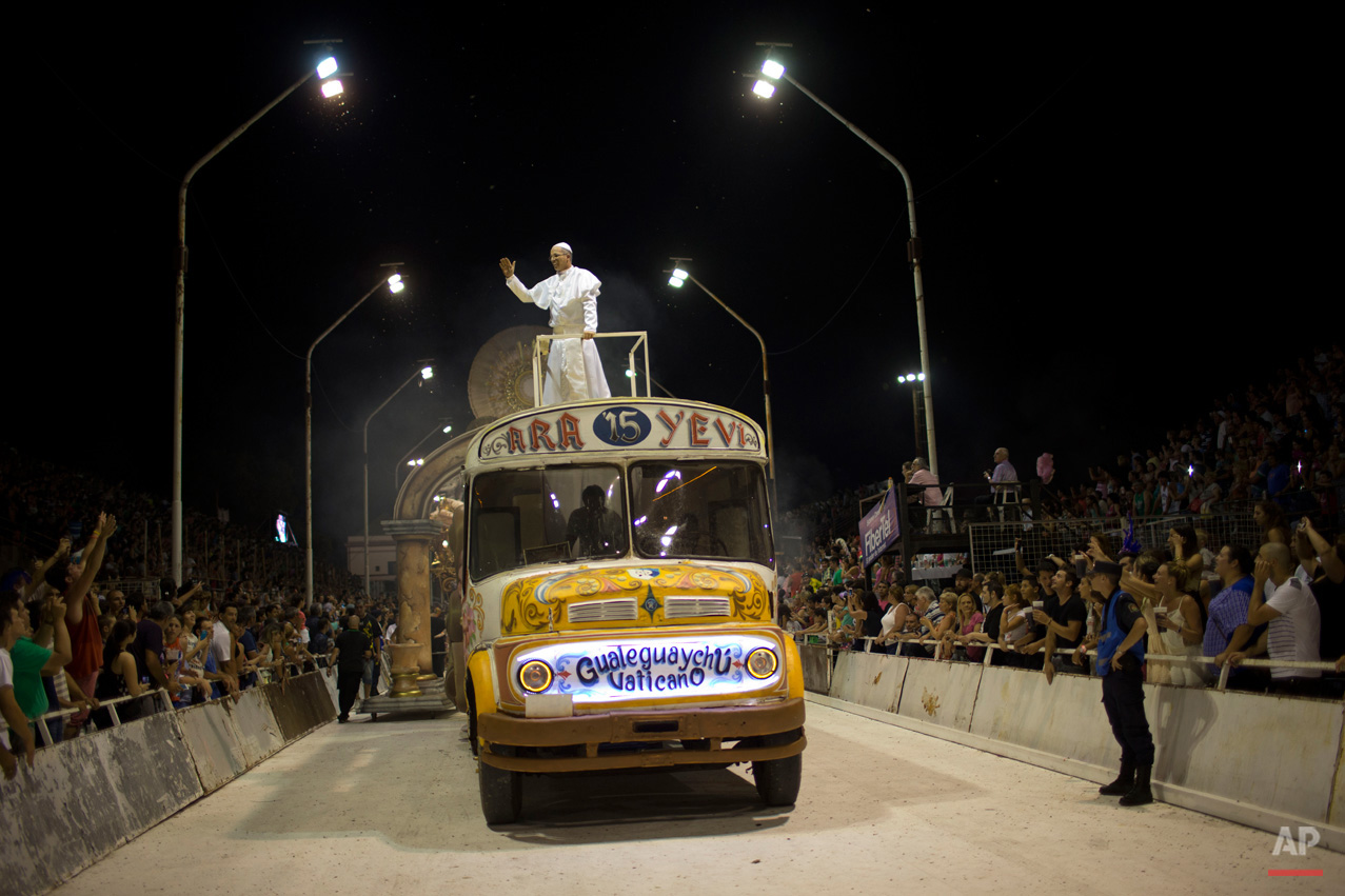 In this Jan. 11, 2015, photo, Roman Figun, a local lawyer, performs the role of Pope Francis with the Ara Yevi samba school as he stands on a bus representing his humble arrival to the Vatican during carnival celebrations in Gualeguaychu, Argentina. Ara Yevi, one of the three samba schools performing this year, used Pope Francis as their central theme. (AP Photo/Natacha Pisarenko)