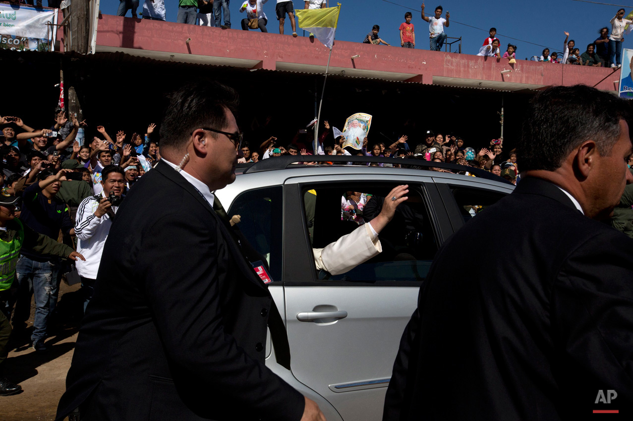In this July 10, 2015, photo, Pope Francis waves from a car as he leaves Palmasola prison after visiting prisoners in Santa Cruz, Bolivia. Pope Francis wrapped up his pilgrimage to Bolivia with a visit to its notoriously violent and overcrowded Palmasola prison, where inmates have the run of the place, drugs are cheaper than on the street and money buys survival. (AP Photo/Rodrigo Abd)