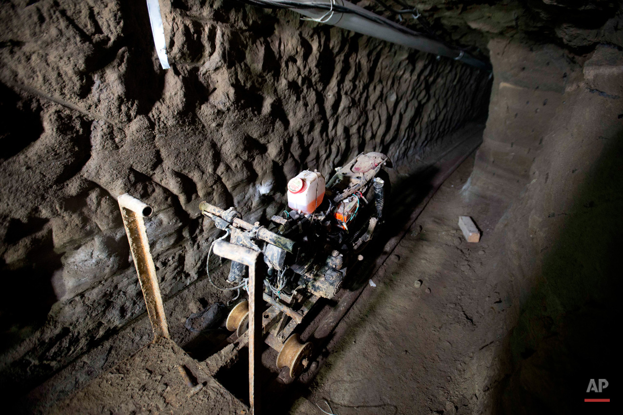 In this July 14, 2015, photo, a motorcycle adapted to a rail sits in the tunnel under the half-built house where according to authorities, drug lord Joaquin "El Chapo" Guzman made his escape from the Altiplano maximum security prison in Almoloya, west of Mexico City. A widespread manhunt that included highway checkpoints, stepped up border security and closure of an international airport failed to turn up any trace of Guzman after he escaped through an underground tunnel in his prison cell. (AP Photo/Eduardo Verdugo)
