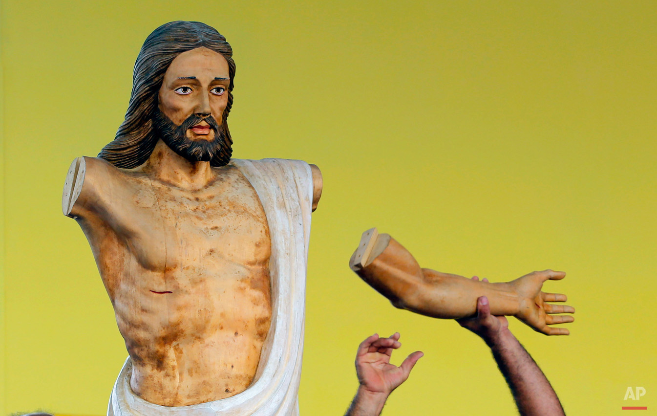 In this Sept. 17, 2015, photo, a worker prepares to fit a wooden arm onto a Christ statue during preparations of the altar where Pope Francis will celebrate Mass in the Plaza of the Revolution, in Havana, Cuba. When Francis arrives in Havana on Sept. 19, he'll find his church ministering to more Cubans than at any time since the 1959 revolution that brought Fidel Castro to power. (AP Photo/Desmond Boylan)