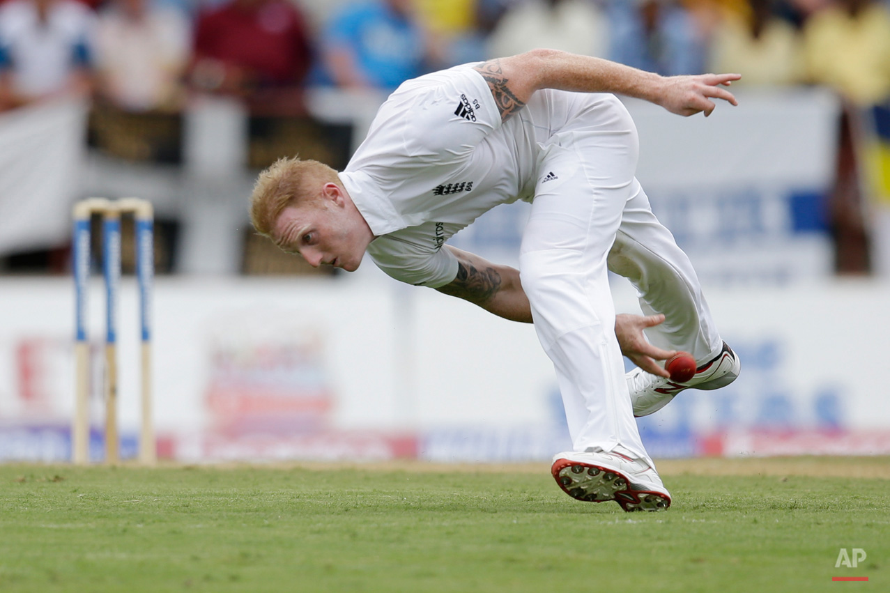 In this April 21, 2015, photo, England's bowler Ben Stokes fields a shot played by Marlon Samuels during day one of their second Test match at the National Stadium in St. George's, Grenada. (AP Photo/Ricardo Mazalan)