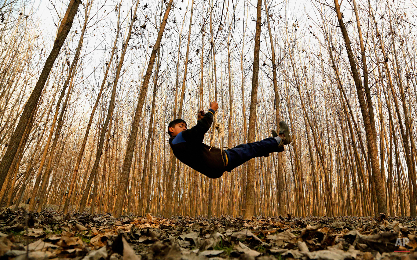  A Kashmiri boy plays on a swing in Srinagar, India, Thursday, Jan. 15, 2015. Set in the Himalayas at 5,600 feet above sea level, Kashmir is a green, saucer-shaped valley surrounded by snowy mountain ranges with over 100 lakes dotting its highlands a