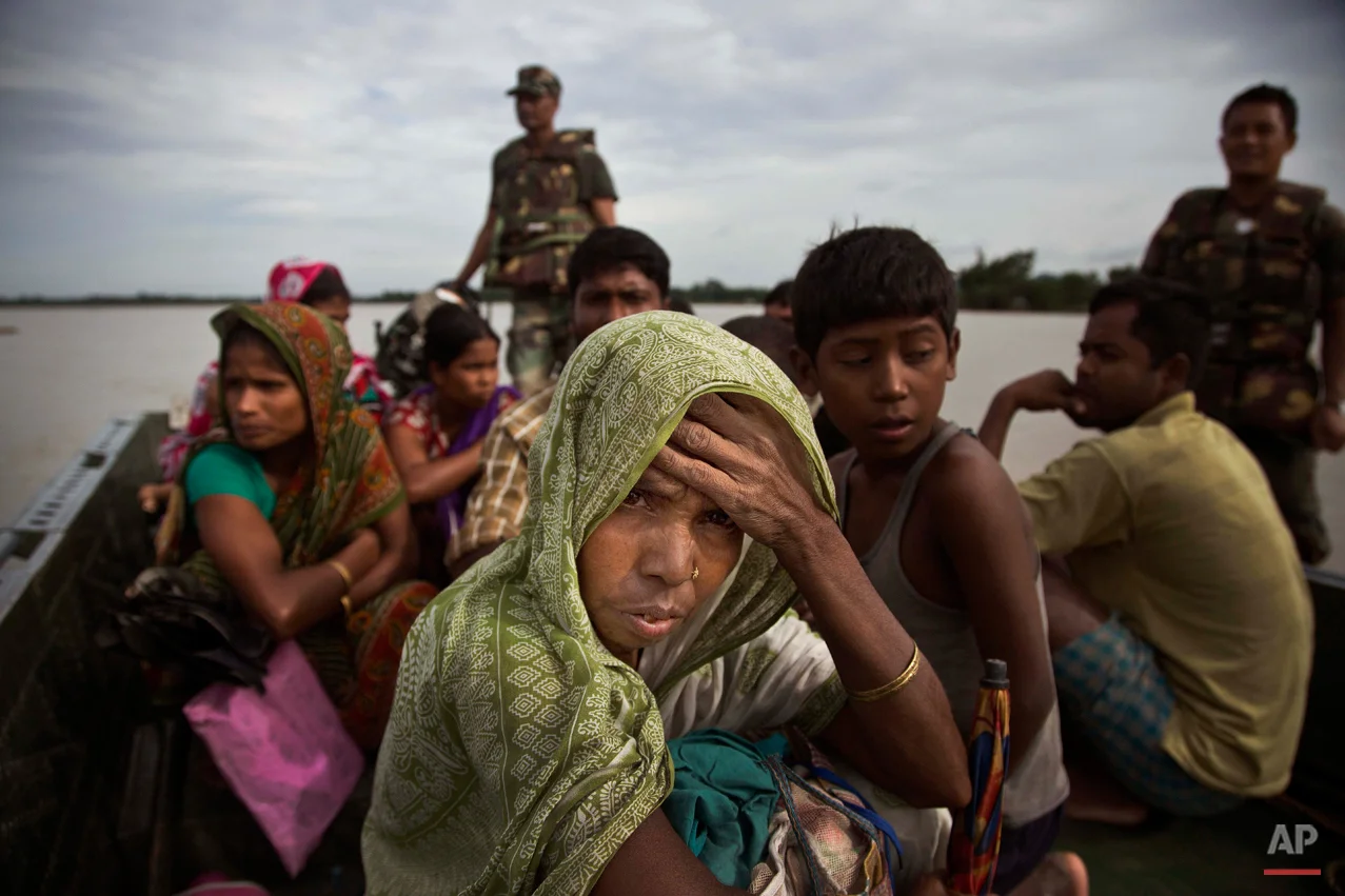 In this Aug. 21, 2015 photo, an Indian woman watches from an army boat as she along with others is transported to safer areas from flood affected Jaraguri village, about 160 kilometres (99 miles) west of Gauhati, India. Incessant rainfall in catchment areas have led to rise in water level of the Brahmaputra river and its tributaries, inundating several districts of both Upper and Lower Assam, according to local news reports. (AP Photo/Anupam Nath)