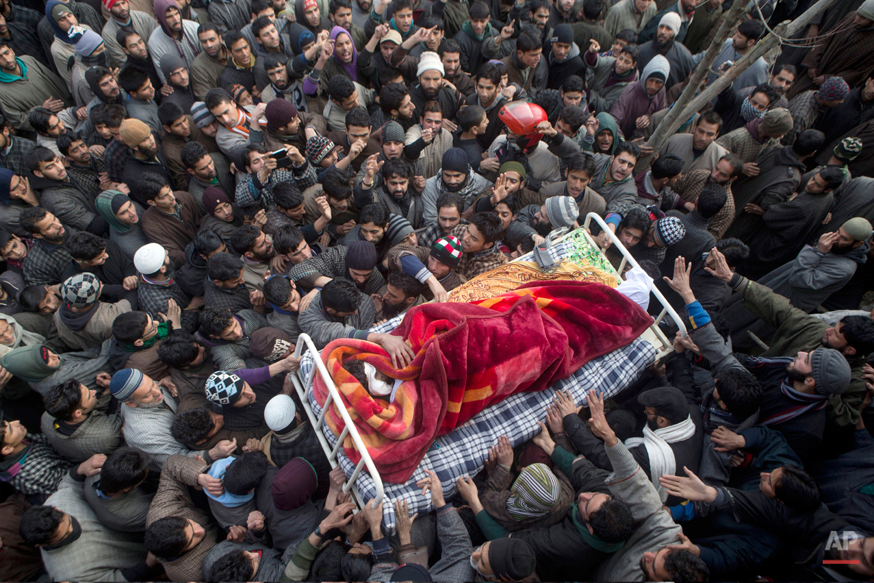 In this Friday, Jan. 16, 2015 photo, Kashmiri Muslim villagers carry the body of Ishfaq Ahmed Malik, a suspected local militant during his funeral procession in Arwani, some 55 kilometers (35 miles) south of Srinagar, India. Indian soldiers and poli
