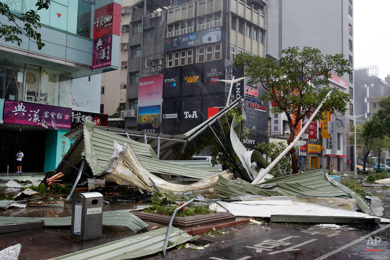  In this Aug. 8, 2015 photo, a street corner is filled with a mangled rooftop brought down by strong winds from Typhoon Soudelor in Taipei, Taiwan. Soudelor brought heavy rains and strong winds to the island Saturday with winds speeds over 170 km per