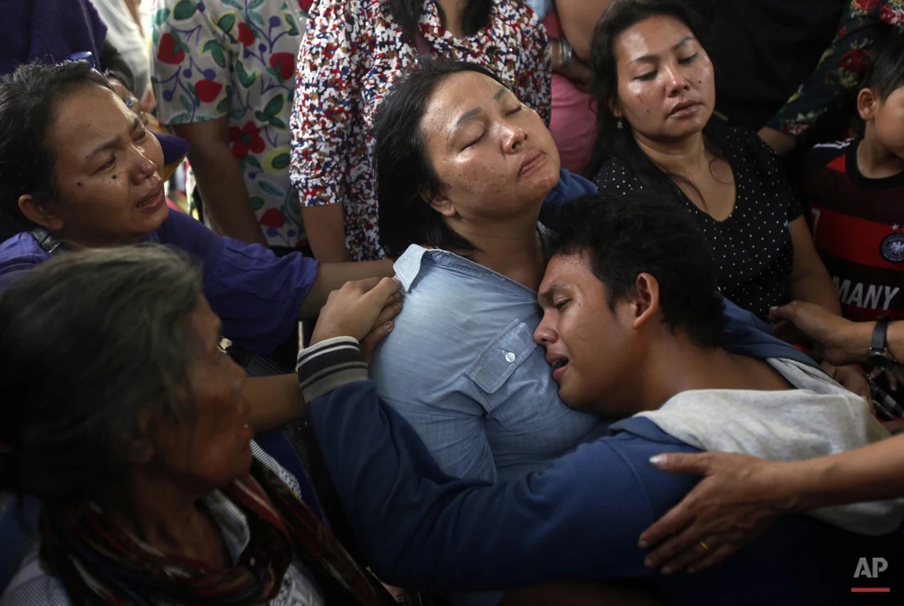 In this Wednesday, July 1, 2015, photo, family members of one of the victims of a military plane that crashed on Tuesday comfort each other at a hospital in Medan, North Sumatra, Indonesia. The C-130 Hercules crashed shortly after takeoff in the country's third largest city on June 30. (AP Photo/Binsar Bakkara)