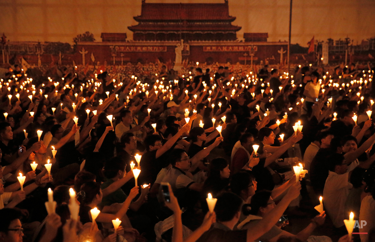  In this Thursday, June 4, 2015, photo, people attend a candlelight vigil at Victoria Park in Hong Kong. Tens of thousands of Hong Kongers joined the candlelight vigil Thursday night marking  the 1989 student-led Tiananmen Square protests. (AP Photo/