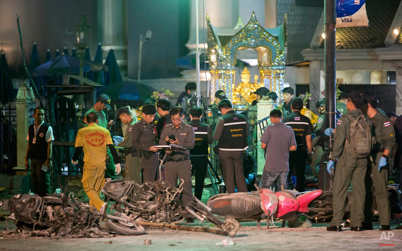In this Aug. 17, 2015 photo, police investigate the scene at the Erawan Shrine after an explosion in Bangkok. Police in Thailand said Saturday, Sept. 26, 2015, they have gathered enough evidence to prosecute two arrested men whom they accuse of carrying out August's deadly Bangkok bombing.(AP Photo/Mark Baker)