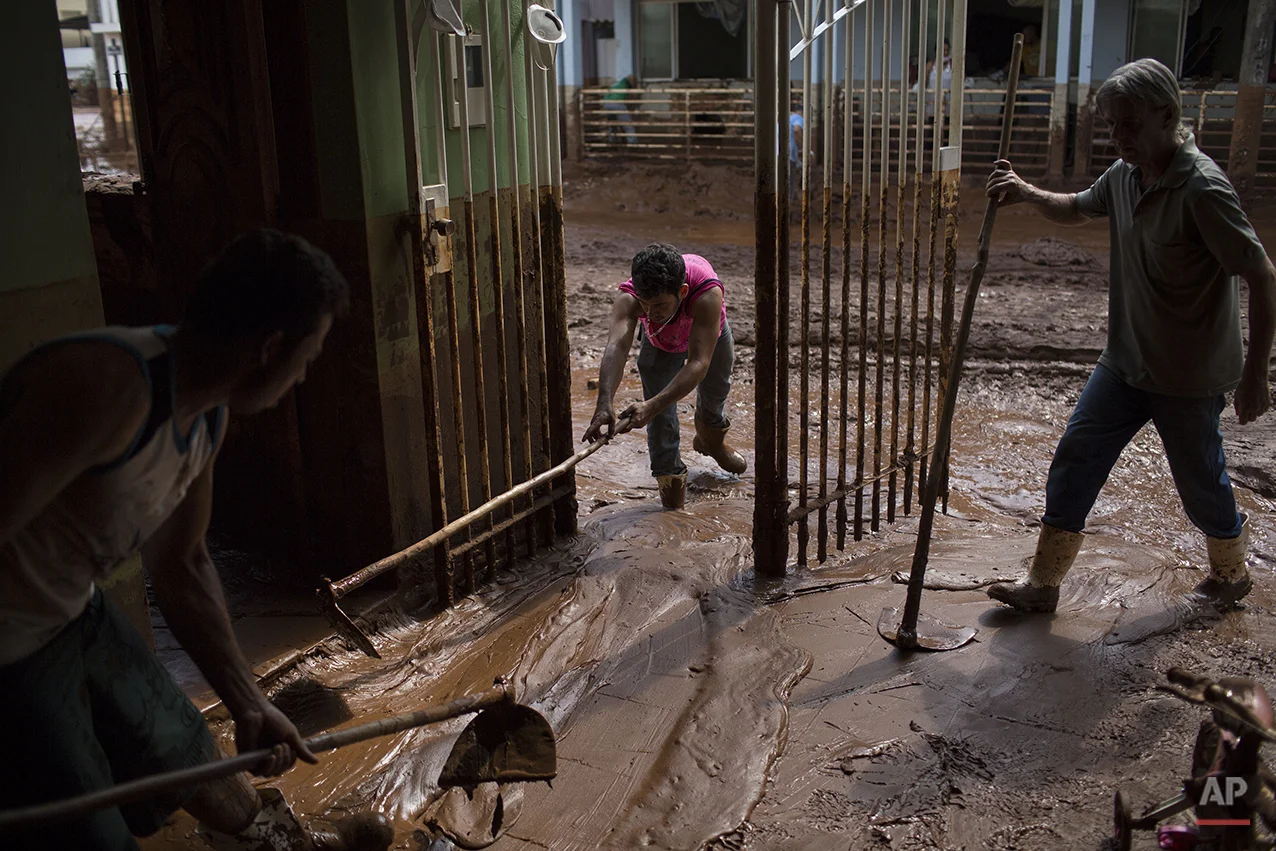  People remove mud from a damaged home in Barra Longa after a dam burst on Thursday in Minas Gerais state, Brazil, Saturday, Nov. 7, 2015. (AP Photo/Felipe Dana) 