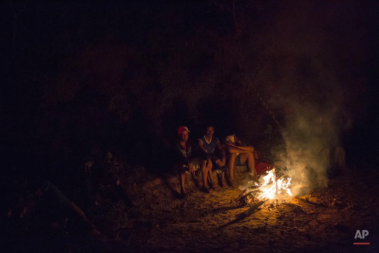  Residents sits by a bonfire after evacuating their houses at the small town of Bento Rodrigues after a dam burst on Thursday, in Minas Gerais state, Brazil, Friday, Nov. 6, 2015.&nbsp;(AP Photo/Felipe Dana) 