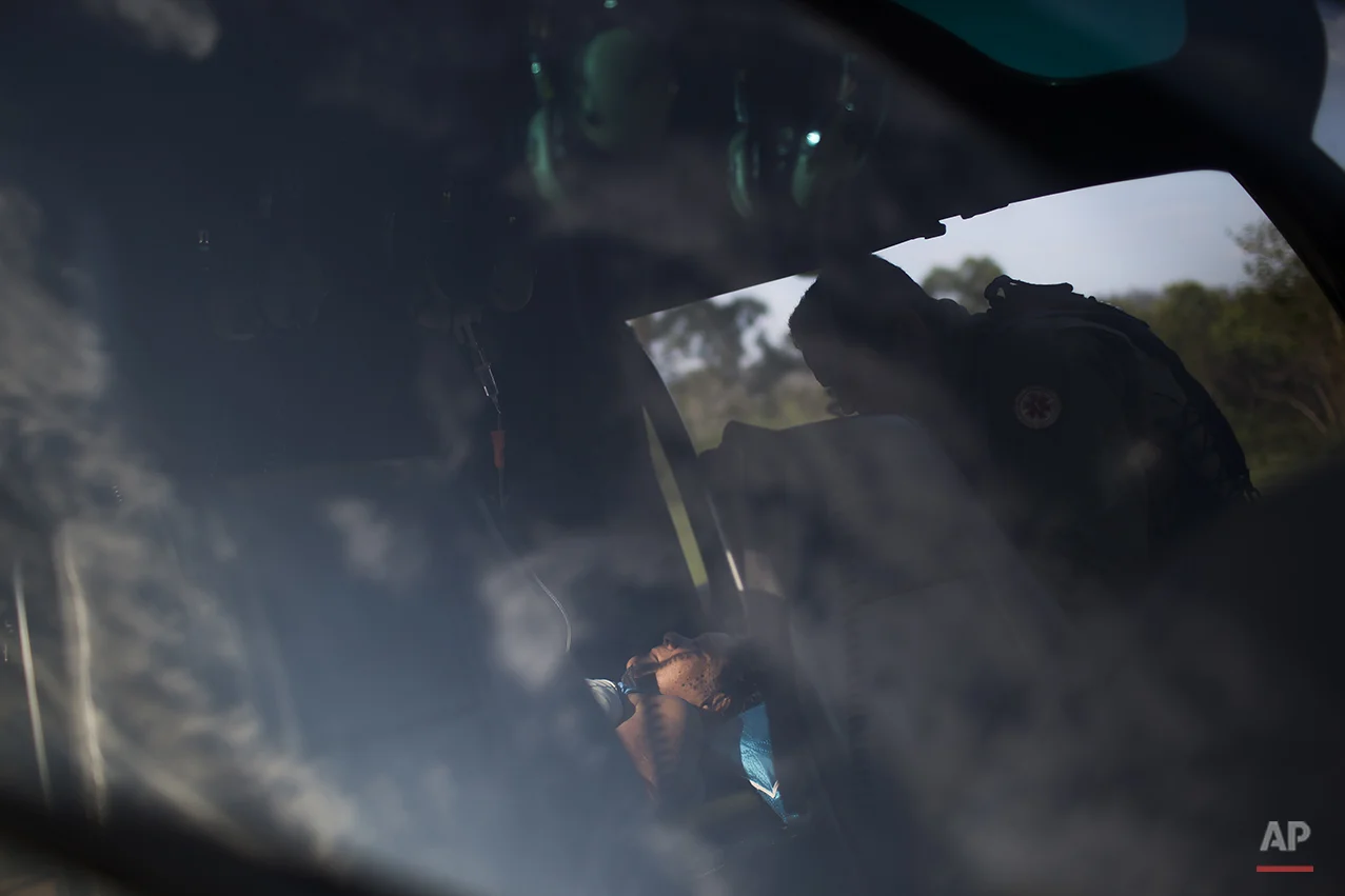  A woman is evacuated in a helicopter at the small town of Bento Rodrigues after a dam burst on Thursday, in Minas Gerais state, Brazil, Friday, Nov. 6, 2015. (AP Photo/Felipe Dana) 