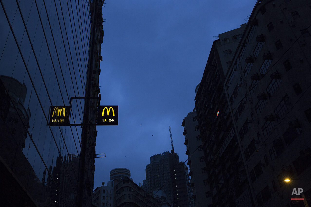  In this Nov. 12, 2015 photo, a sign of a 24-hour McDonald’s branch is seen early morning in Hong Kong. The recent death of a woman at a Hong Kong McDonald’s, where her body lay slumped at a table for hours unnoticed by other diners, has focused atte