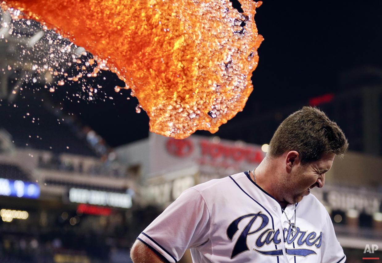  San Diego Padres second baseman Jedd Gyorko braces himself as he is doused in liquid after hitting a walk-off single to defeat the San Francisco Giants in a baseball game Wednesday, Sept. 23, 2015, in San Diego. The Padres won, 5-4. (AP Photo/Gregor