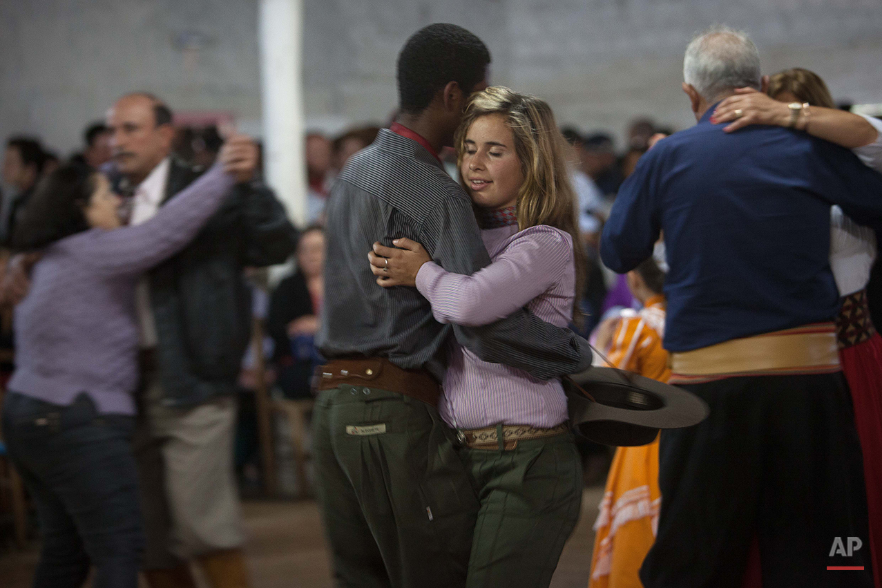  In this Sept. 19, 2015 photo, a couple wearing traditional clothes, dance during Semana Farroupilha or “Ragamuffin” week, in Alegrete municipality, Rio Grande do Sul state, Brazil. During the celebration, cowboy culture is kept alive with traditiona