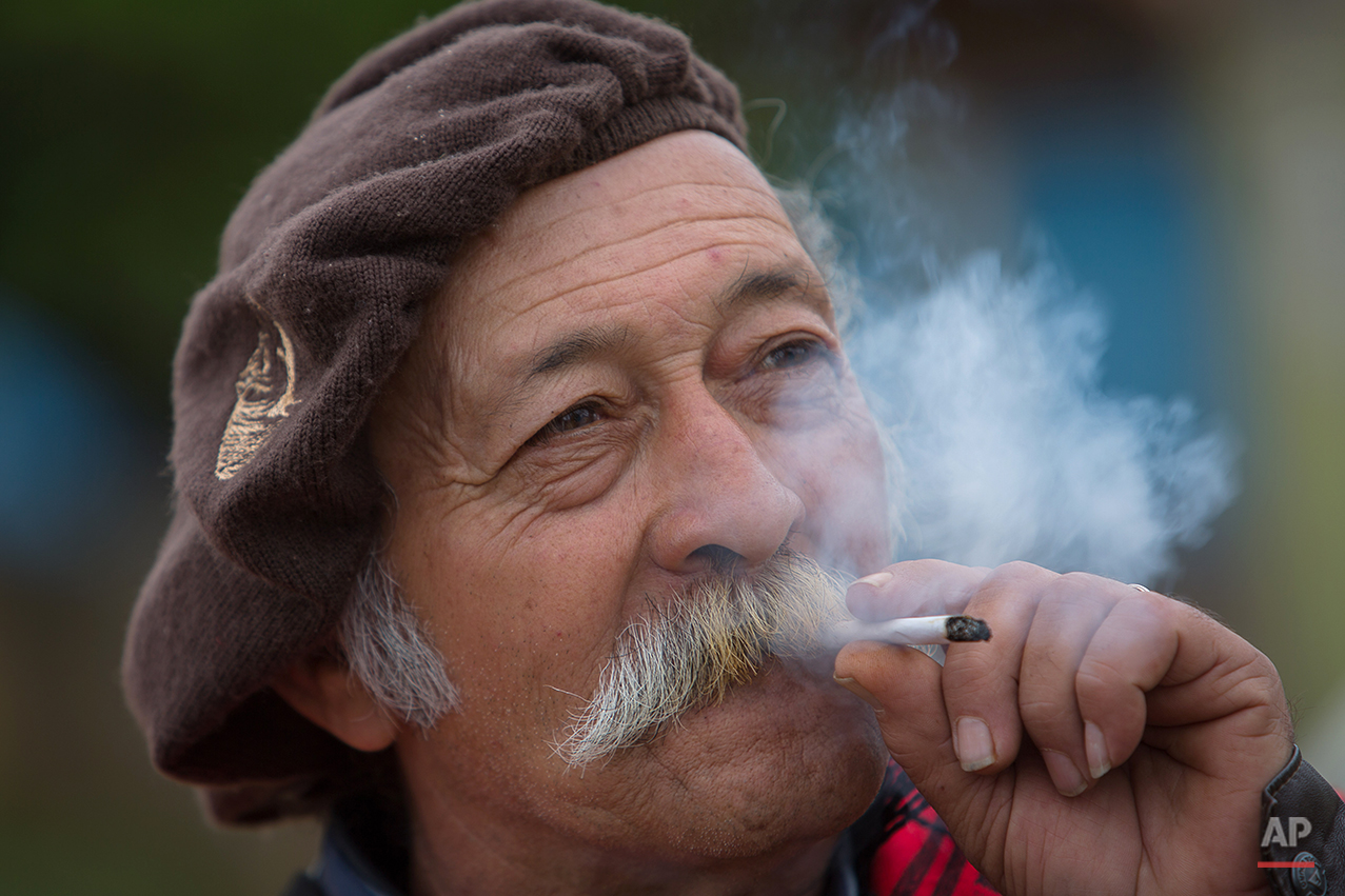  In this Sept. 19, 2015 photo, gaucho Jose Newton Franca Silveira, 66, smokes a cigarrette during the Semana Farroupilha or “Ragamuffin” week, in Alegrete municipality, Rio Grande do Sul state, Brazil. Each September, the locals keep their cowboy cul