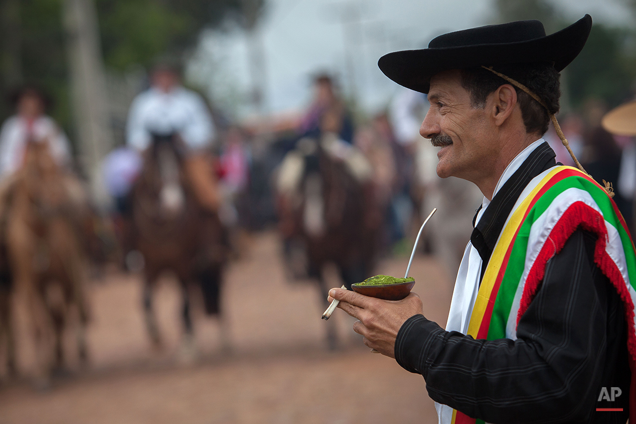  In this Sept. 19, 2015 photo, gaucho Vanderlei Carvalho, 54, drinks mate during the Semana Farroupilha or “Ragamuffin” week, in Alegrete municipality, Rio Grande do Sul state, Brazil. Mate is a traditional South American infused drink, it is prepare