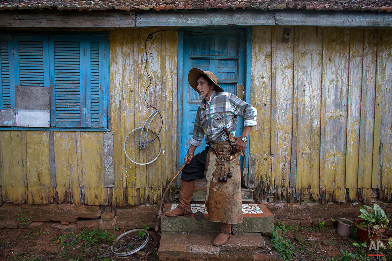  In this Sept. 19, 2015 photo, gaucho Leo Moura, poses for a photo in front his home during the Semana Farroupilha or “Ragamuffin” week, in Alegretemunicipality, Rio Grande do Sul state, Brazil. Each September, the locals keep their cowboy cultural a