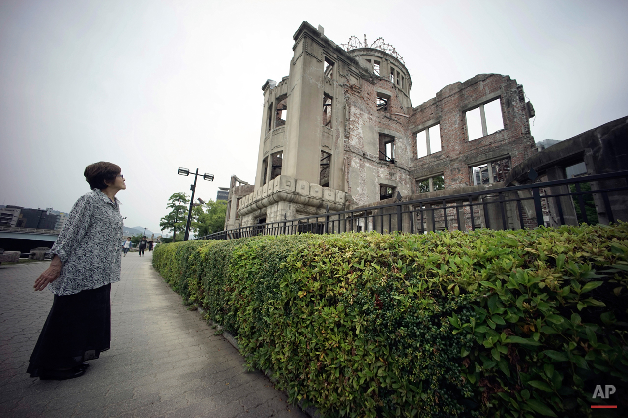  In this July 3, 2015 photo, Kimie Mihara, a survivor of the 1945 atomic bombing, looks at the Atomic Bomb Dome, as it is known today in Hiroshima, Hiroshima Prefecture, southern Japan. Built in 1915, the dome building was a rare example of Western a