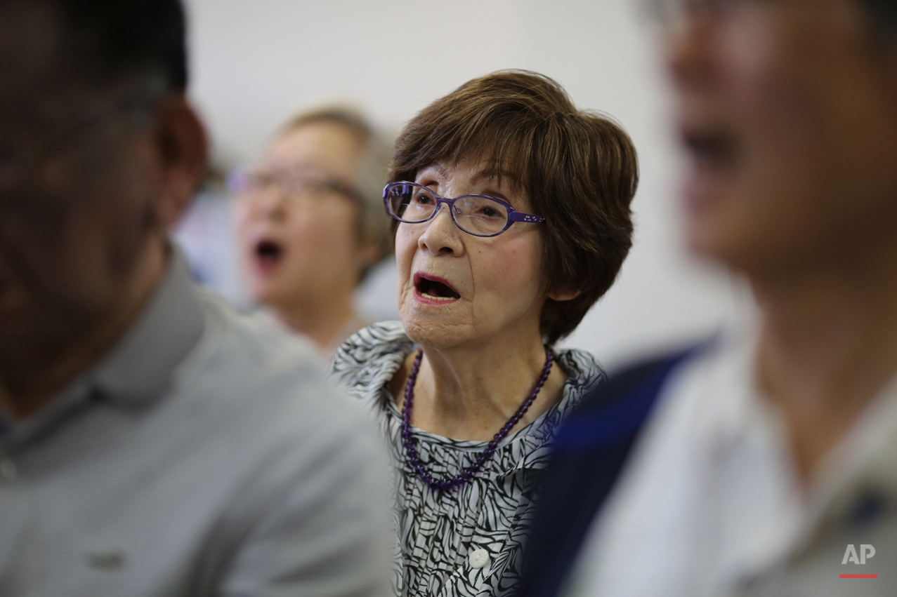  In this July 3, 2015 photo, Kimie Mihara, center, a survivor of the 1945 atomic bombing, participates a chorus at a community center in Hiroshima, Hiroshima Prefecture, southern Japan. On the morning of Aug. 6, 1945, the Atomic Bomb Dome, as it is k
