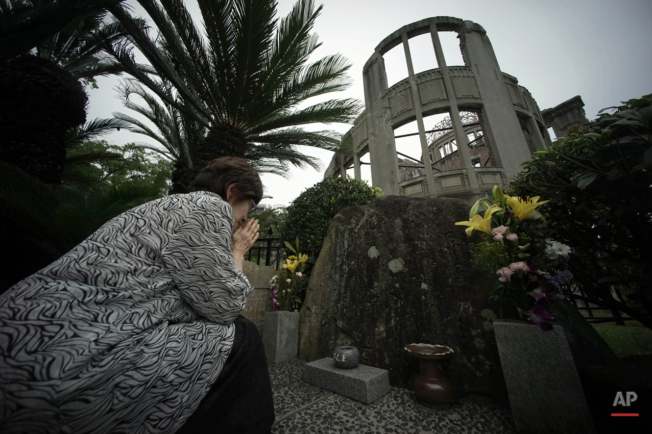  In this July 3, 2015 photo, Kimie Mihara, a survivor of the 1945 atomic bombing, prays at the cenotaph at the Atomic Bomb Dome, as it is known today in Hiroshima, Hiroshima Prefecture, southern Japan. Built in 1915, the dome building was a rare exam
