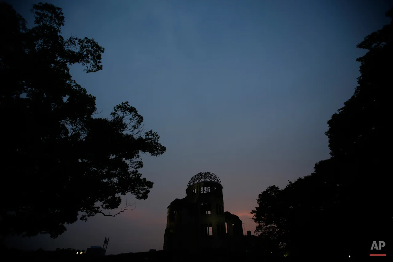  In this July 3, 2015 photo, the Atomic Bomb Dome, as it is known today is seen at dusk in Hiroshima, Hiroshima Prefecture, southern Japan. In its postwar rebuilding, Hiroshima decided to conserve the dome as it was in 1961, leaving it as an icon of 