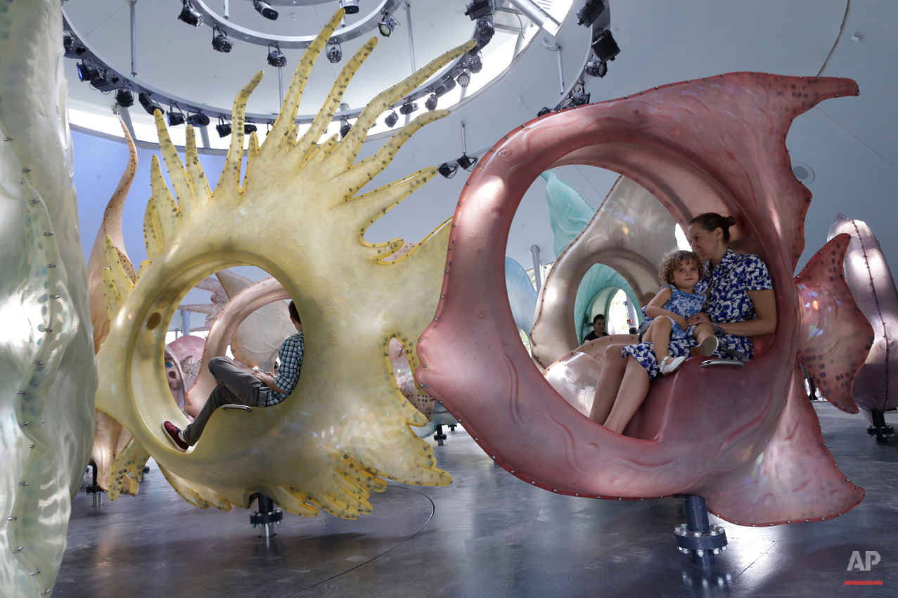  Samantha Rudin Earls and her daughter Elle, 3, take an inaugural ride on the SeaGlass Carousel at the Battery, Thursday, Aug. 20, 2015, in New York. The ride will be open to the public seven days a week from 10 am to 10 pm. (AP Photo/Mary Altaffer) 