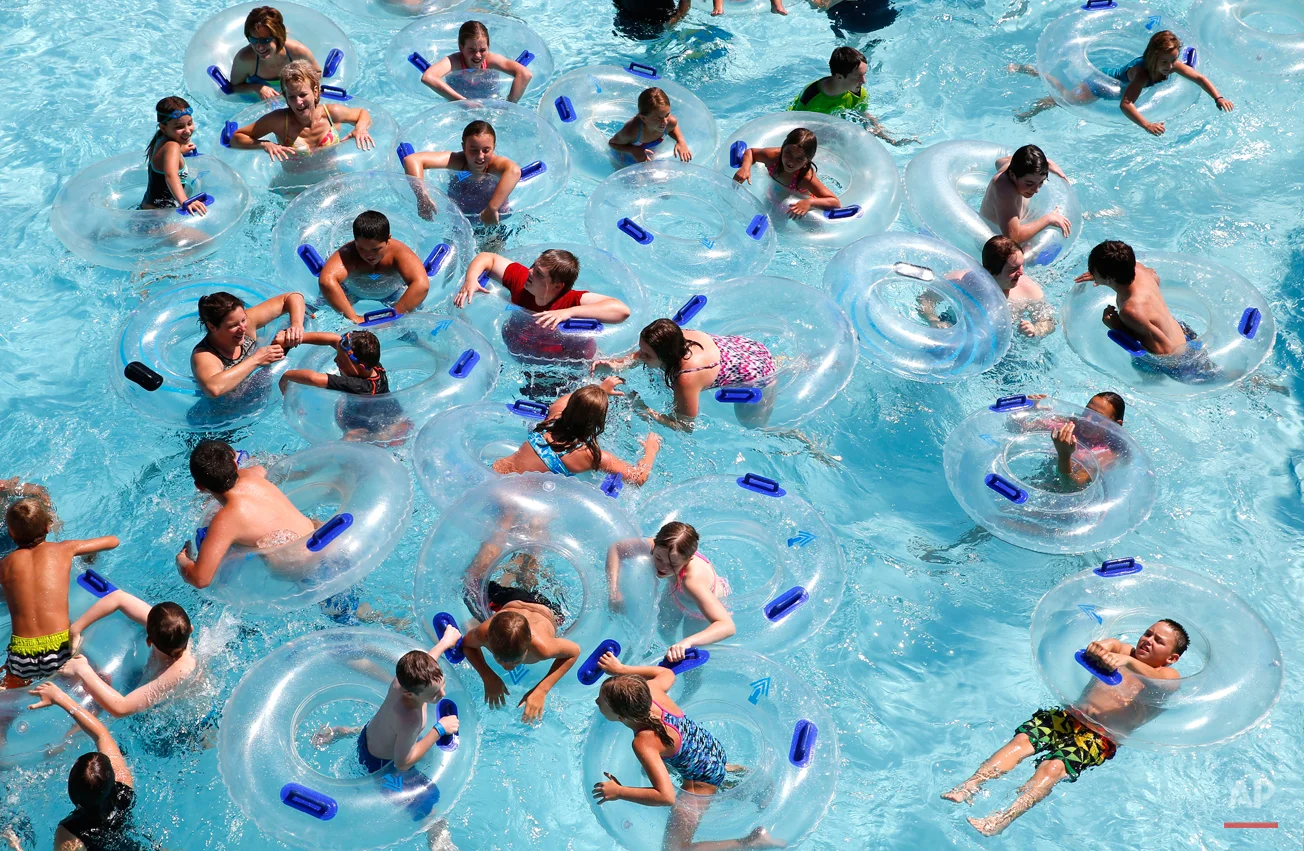 Swimmers use tubes in the wave pool at the Rolling Hills Water Park in Ypsilanti, Mich., Wednesday, Aug. 5, 2015. (AP Photo/Paul Sancya)