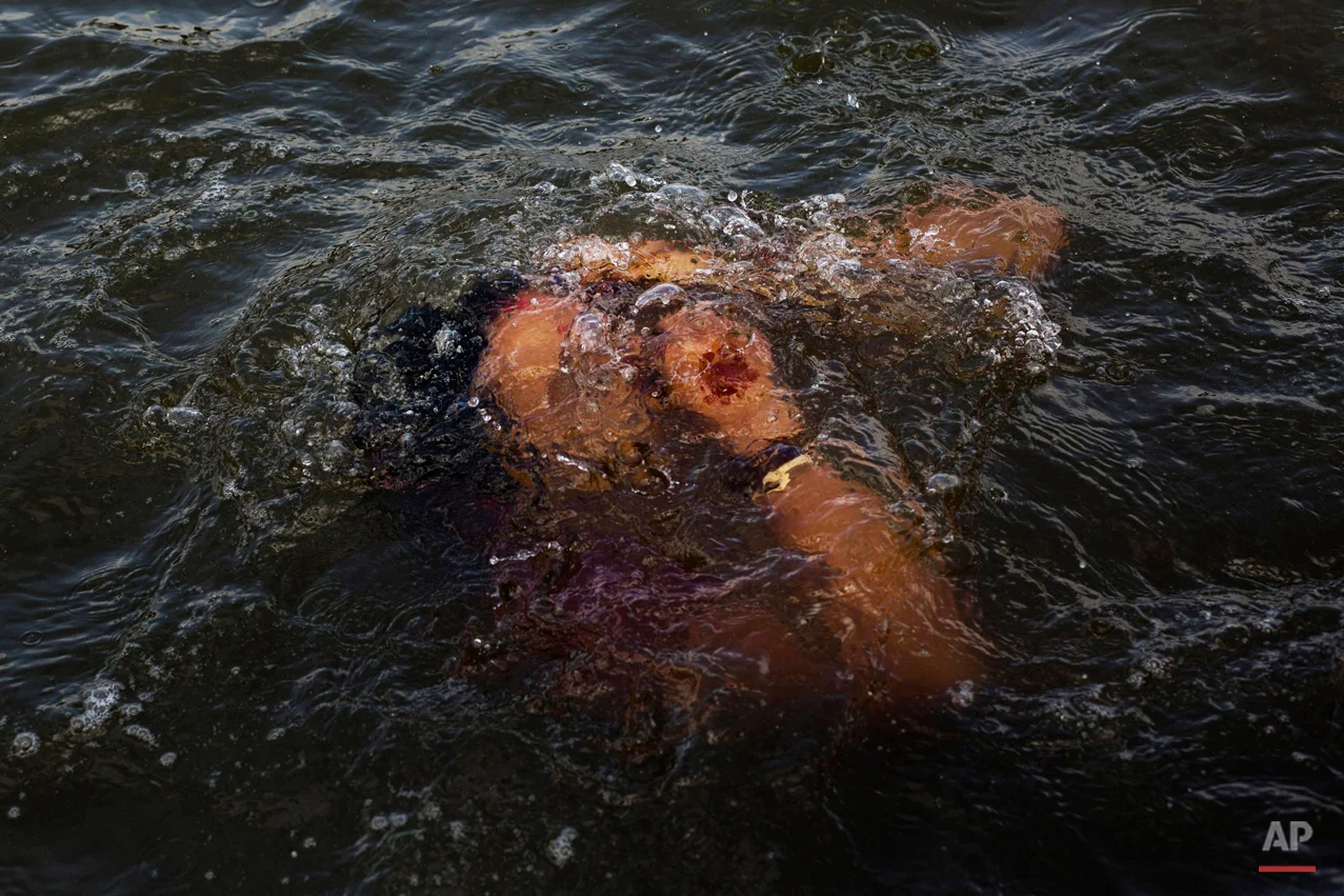  In this Wednesday, Aug. 26, 2015, photo, a Hindu devotee performs a holy dip in the Godavari River during Kumbh Mela, or Pitcher Festival, in Nasik, India. Millions of Hindus are expected to immerse themselves in the Godavari River as a way to clean