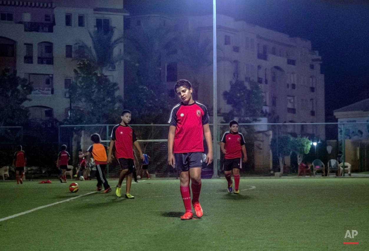  In this picture taken on Nov. 6, 2014, 13-year-old Adham Ehab Anwar, whose policeman father was shot to death in an attack on his station after the bloody security force breakup of Islamist sit-ins in Cairo in 2013, is tired after football training 