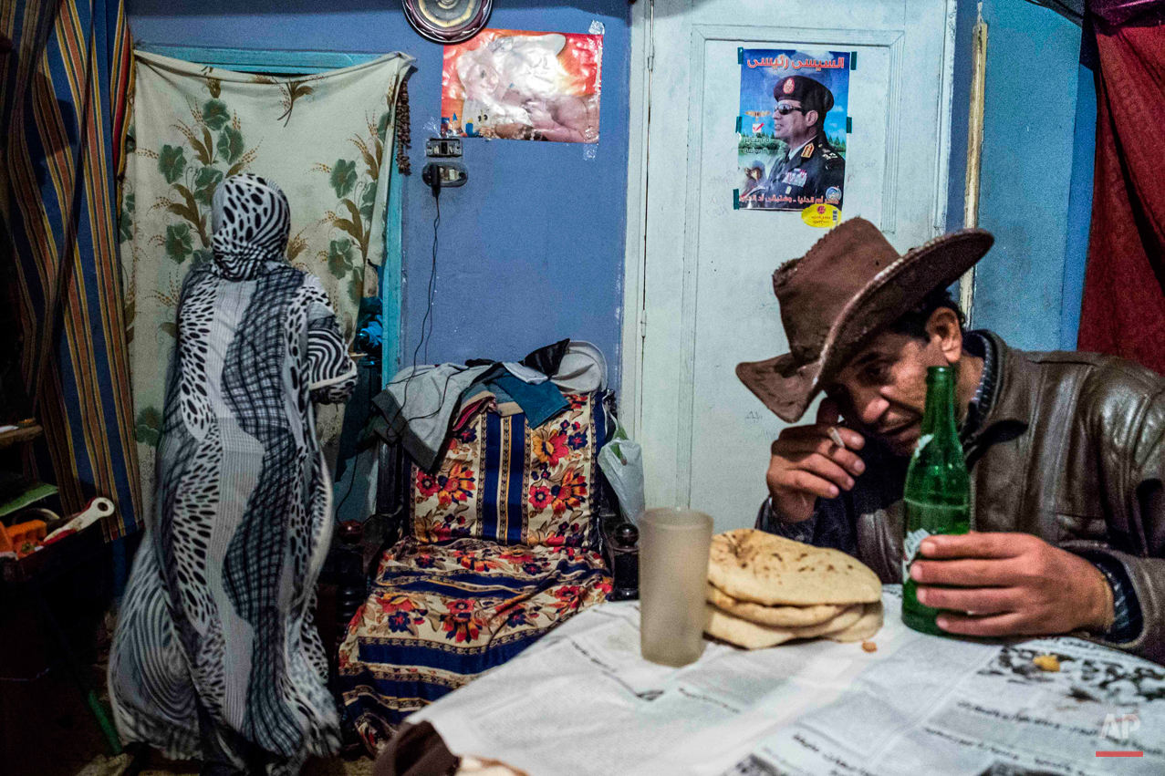  In this picture taken on Dec. 21, 2014, 12-year-old Jihad Abdo Elmasry prepares dinner for her father, who was badly beaten in Tahrir Square in August 2013 for declaring pro-government views, at their home in old Cairo, Egypt. Jihad says she wants t