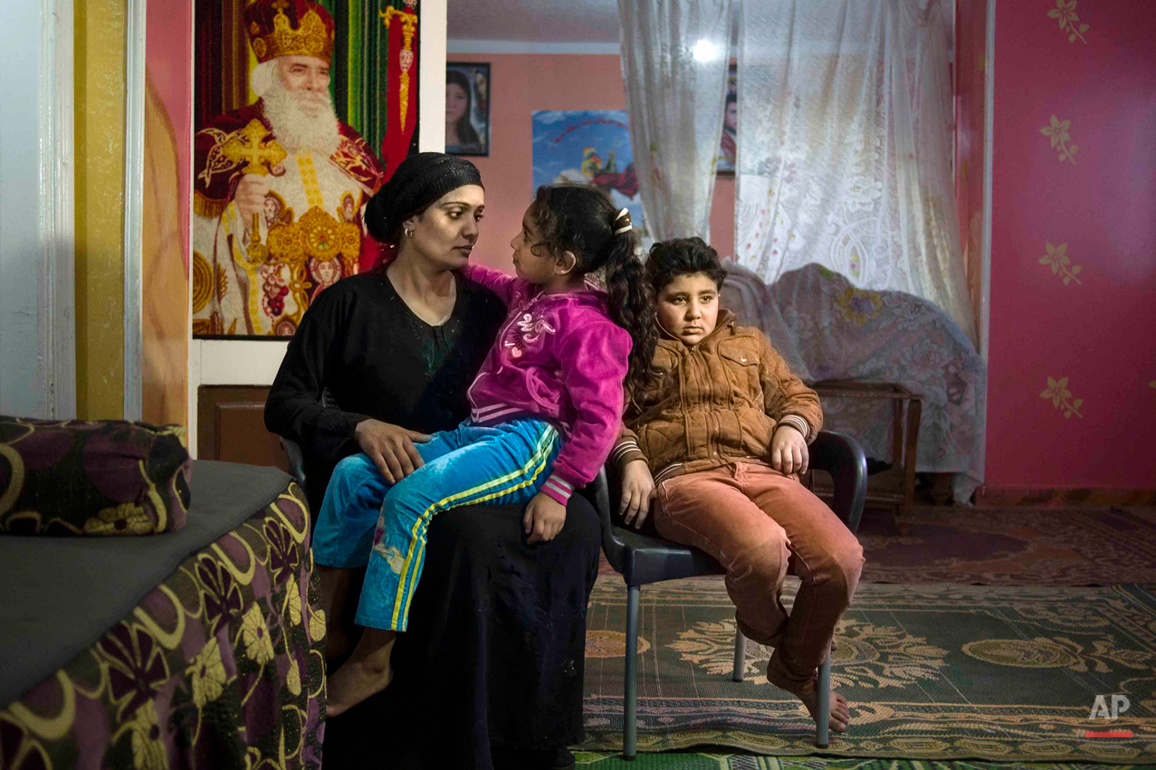  In this picture taken on Feb. 2, 2015, 10-year-old Abanoub Samaan Nazmy, right, rests at his home with his mother and younger sister, in the living room of their home in the Manshiet Nasr neighborhood of Cairo, Egypt. Abanoub, who is a Coptic Christ