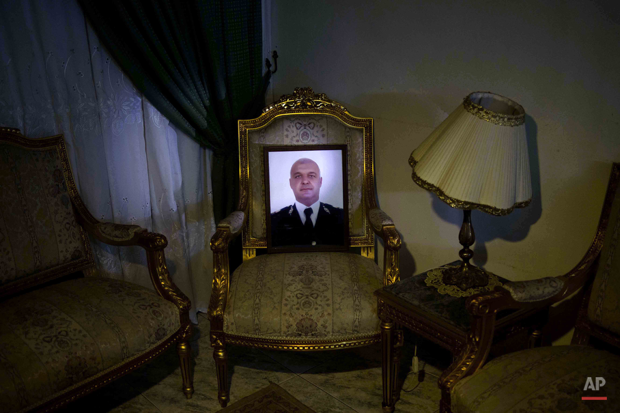  This picture taken on Jan. 30, 2015 shows a portrait of the slain father of Adham Ehab Anwar, who was shot to death in an attack on his station after the bloody security force breakup of Islamist sit-ins in Cairo in 2013, on the chair he used to sit