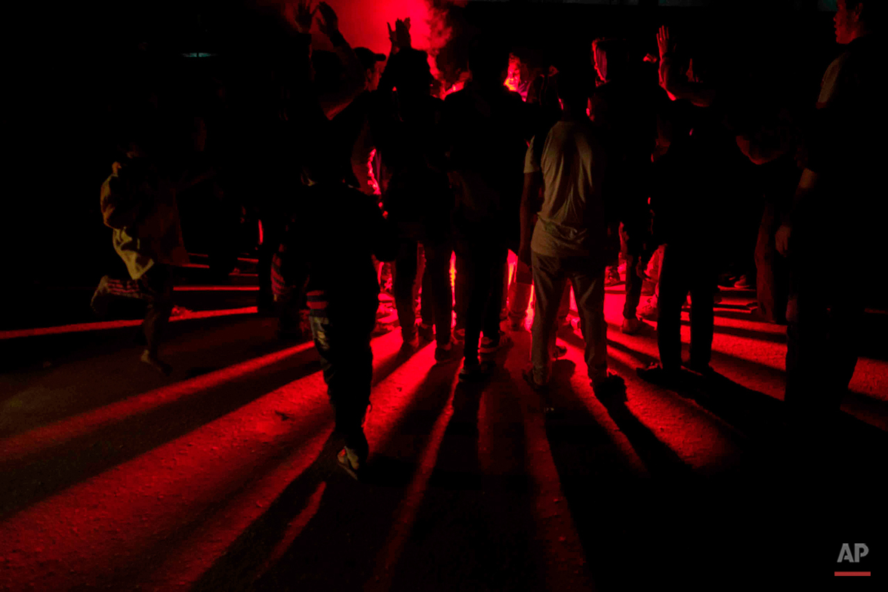  In this picture taken on Dec. 19, 2014, young Muslim Brotherhood football fans known as 'Ultras Nahdawy,' light fireworks during a march against the military overthrow of former President Mohammed Morsi, in Cairo Egypt. Most members of 'Ultras Nahda