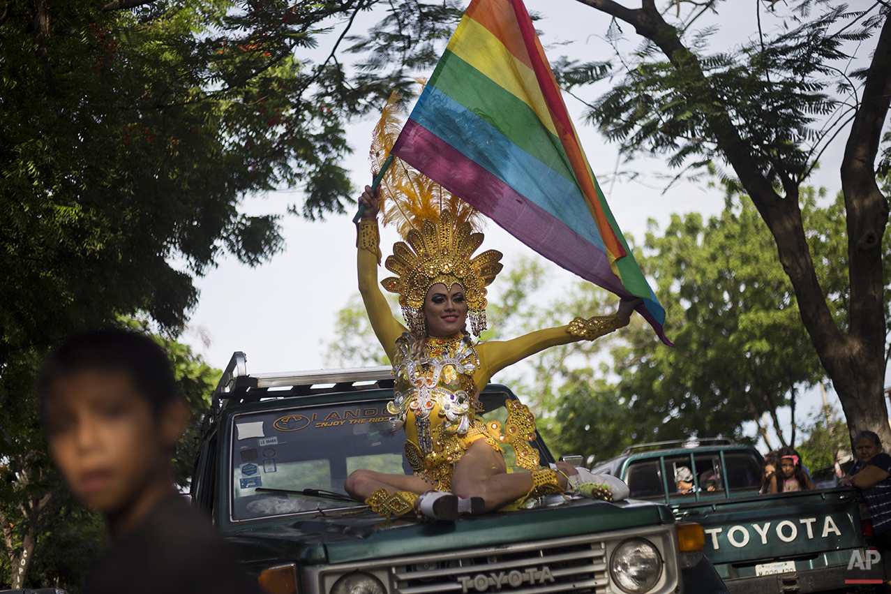  A reveler holds a gay pride flag during a parade celebration in Managua, Nicaragua, Sunday, June 28, 2015. (AP Photo/Esteban Felix) 