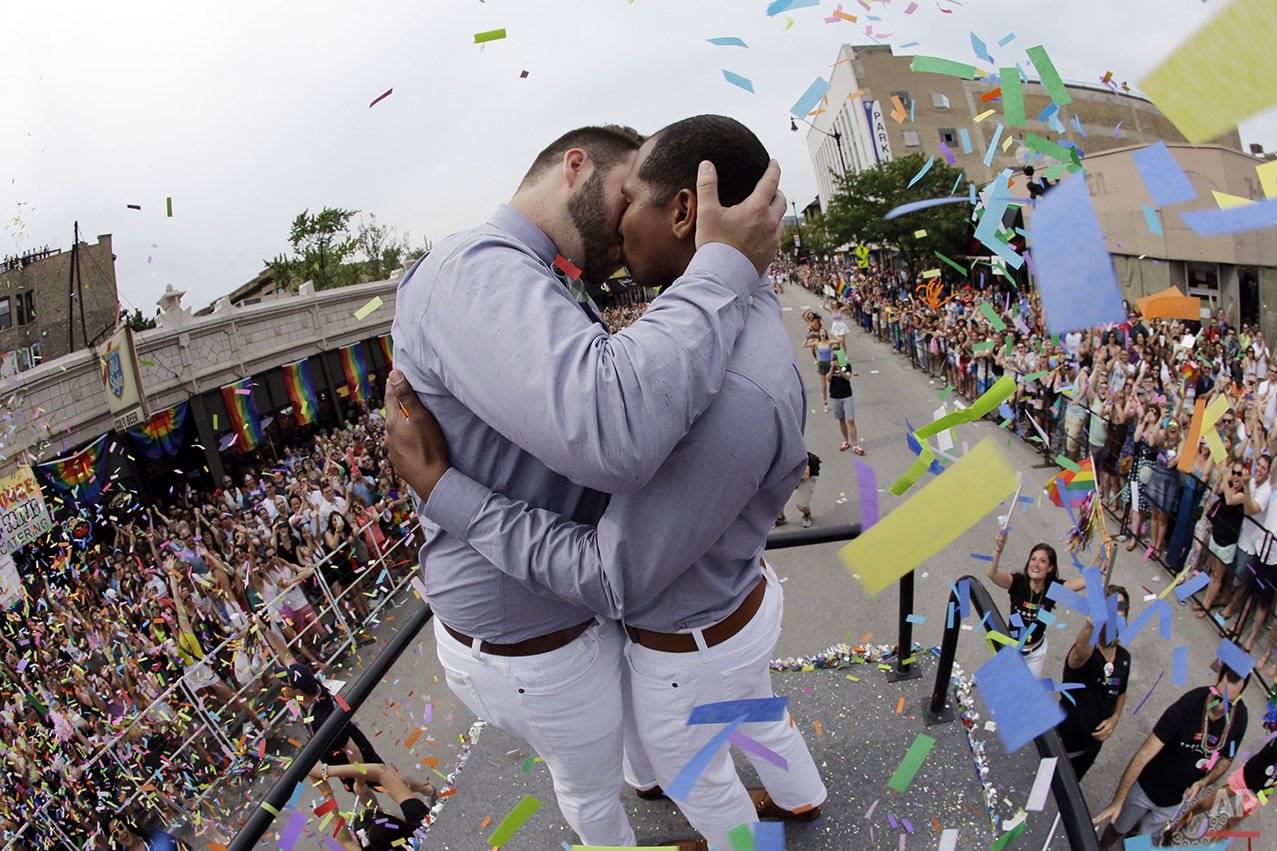 Scotty Brown, 32, left, of Chicago, kisses Roger Knight, 31, of Chicago, as they get married during the Chicago Pride Parade on Broadway Street on Sunday, June 28, 2015, in Chicago. (AP Photo/Nam Y. Huh) 