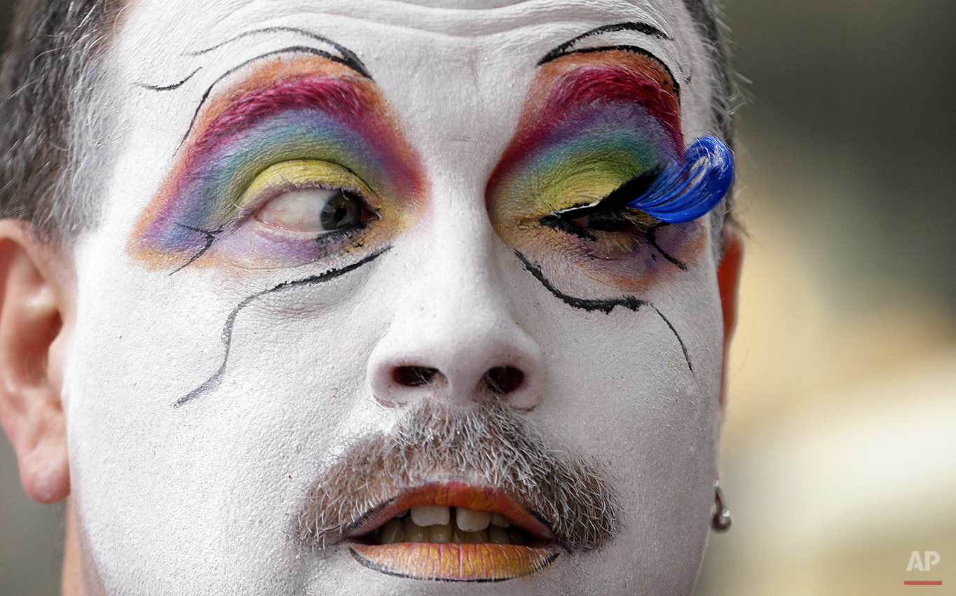  Brian Lavalle, also known as Sister Bebe Jeebus, a member of the Sisters of Perpetual Indulgence, looks across at his newly-applied eyelash as he prepares for the 41st annual Pride Parade Sunday, June 28, 2015, in Seattle. (AP Photo/Elaine Thompson)