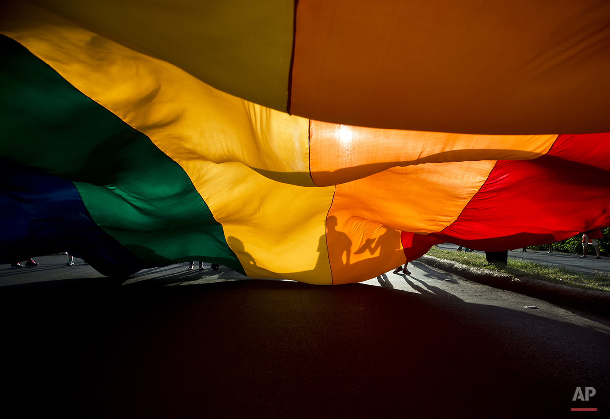  Members of the LGBT movement hold a gay pride flag during a parade celebration in Managua, Nicaragua, Sunday, June 28, 2015. (AP Photo/Esteban Felix) 