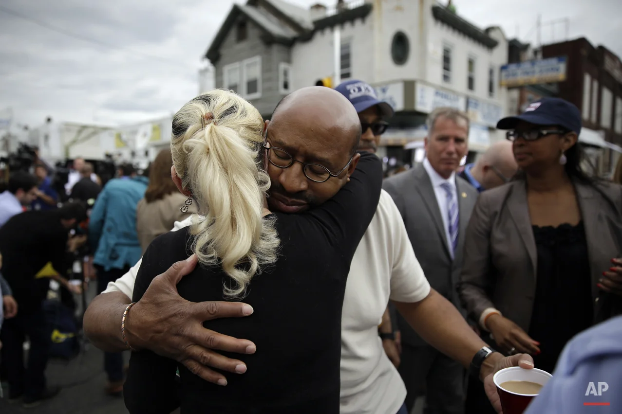  Philadelphia Mayor Michael Nutter, center right, hugs Lori Dee Patterson, a nearby resident, after she handed him a cup of coffee after he spoke at a news conference near the scene of a deadly Amtrak train derailment, Wednesday, May 13, 2015, in Phi