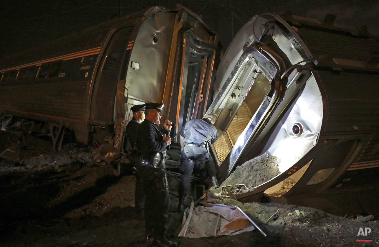 Emergency personnel work the scene of a Amtrak train wreck in Philadelphia, May 12, 2015. (AP Photo/Joseph Kaczmarek)