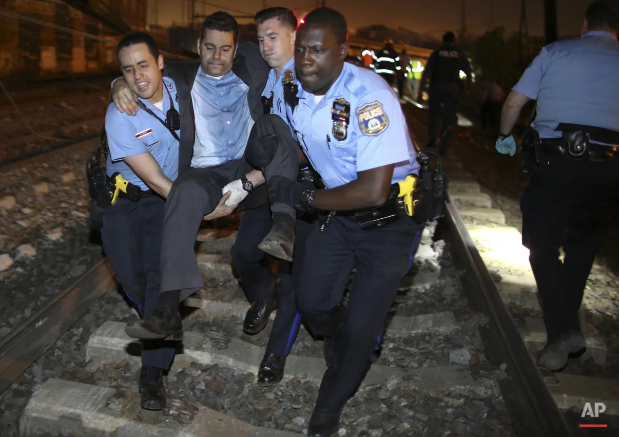  Emergency personnel help a passenger at the scene of a Amtrak train wreck, Tuesday, May 12, 2015, in Philadelphia. (AP Photo/Joseph Kaczmarek) 